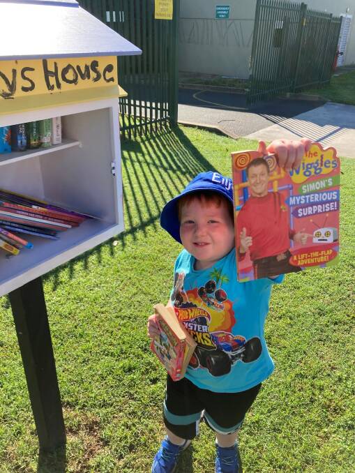 Elijah Fuller borrows a book from the new street library.