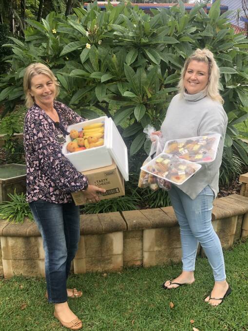 Mid North Coast Local Health District corporate relations coordinator Sharon Fuller collects the donated snacks from campaign founder Rebecca Stockwell.