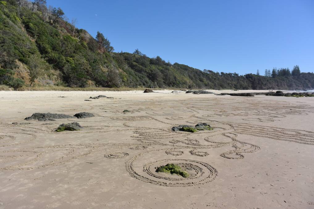 Message in the sand: A sand art design at Shelly Beach celebrates the International Day of Older Persons.