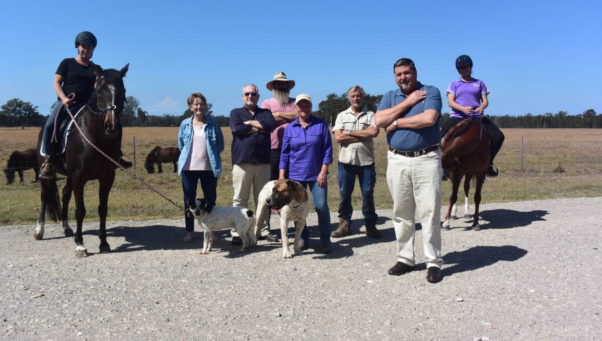 Concerned: The Hatch residents want timely action to fix their road. Pictured are Tracey Houston and her horse Jaz, Chris Smith representing Amanda and Shane Donohoe, Colin Hoddy, Darren Coleman, Julie Redman, Tom Webber, Stuart Redman and Cassie Smith and her horse Pixie. 