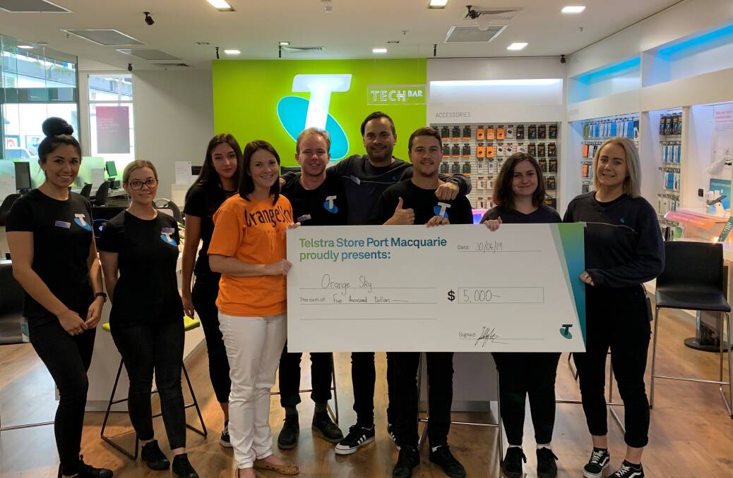Many thanks: Orange Sky service manager Alison Neale accepts the donation from the Telstra Store Port Central team.