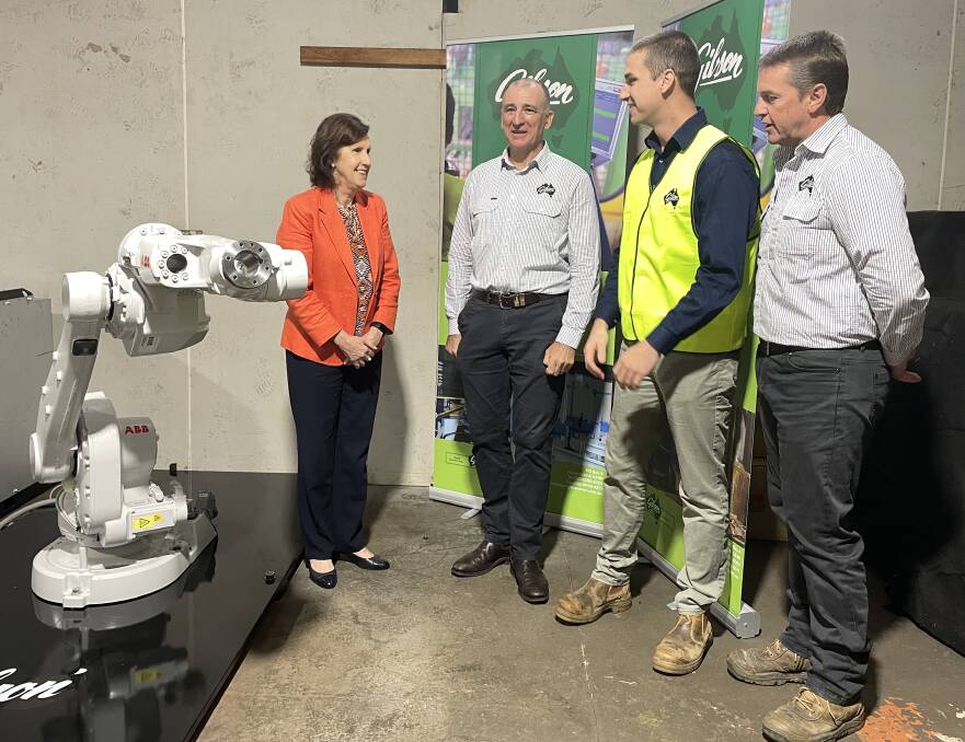 Port Macquarie MP Leslie Williams and AE Gibson & Sons managing director Troy Krogh, general manager Curtis Gibson and automation manager Christian Gibson discuss the grant funding. Picture: Lisa Tisdell