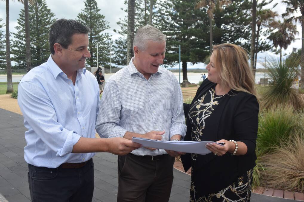 The Nationals Cowper candidate Pat Conaghan, Deputy Prime Minister Michael McCormack and mayor Peta Pinson inspect the plans for the Town Green west upgrade.