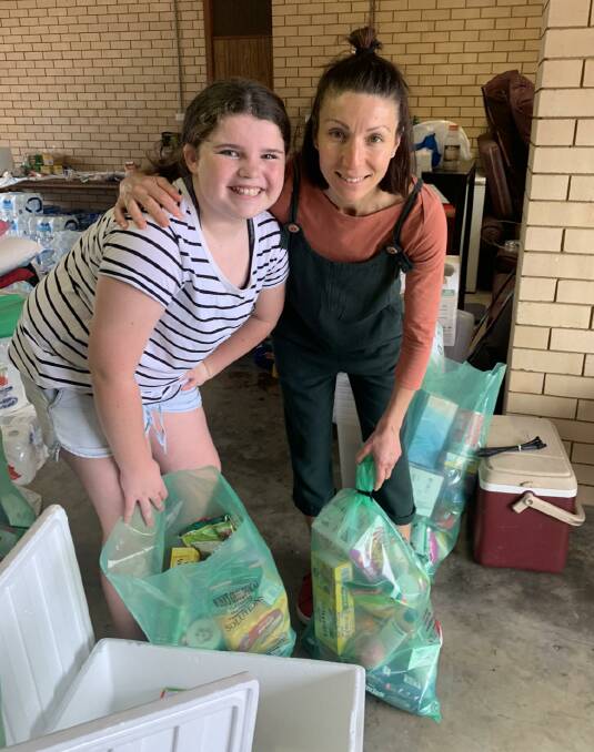 Generosity: Ella Herbert and Mandy Gleeson bag up care packs. Some 250 care packs were delivered.