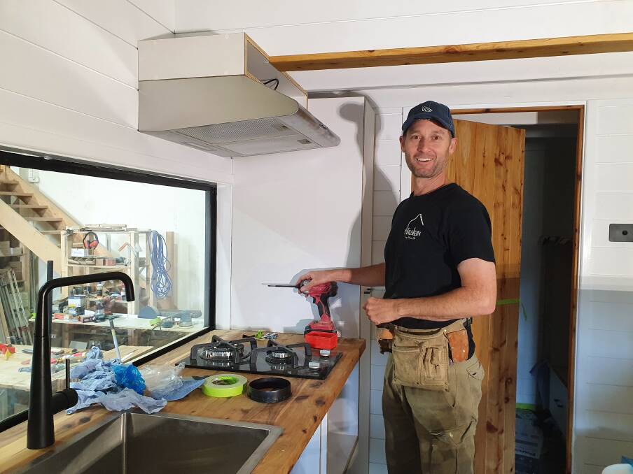 Work in progress: Hauslein Tiny House Co cabinet maker/joiner Gordo Holmes focuses on the kitchen in one of the tiny houses under construction.