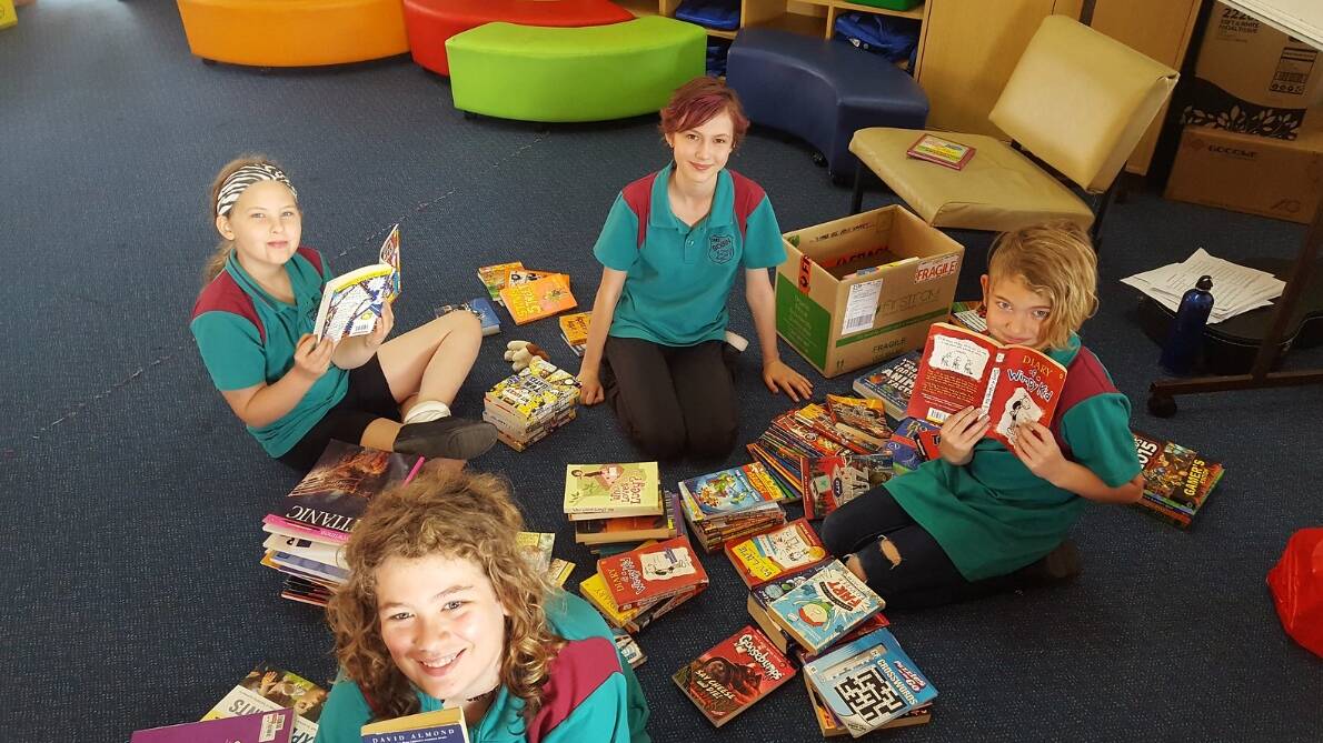 Bobin students at Wingham Public School with books donated to Bobin by Trinity Grammar and Pymble Ladies College. Photo: Sarah Parker