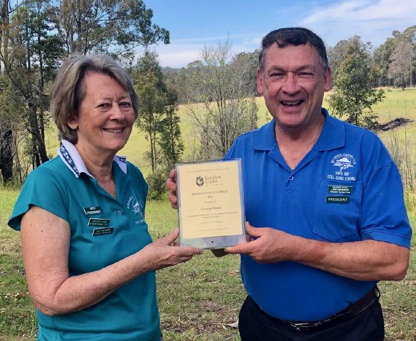 George Hoad being presented with the President of Garden Club of Australlia Inc. Award by Killabakh Garden Club vice president, Heather Scarr. Picture: supplied