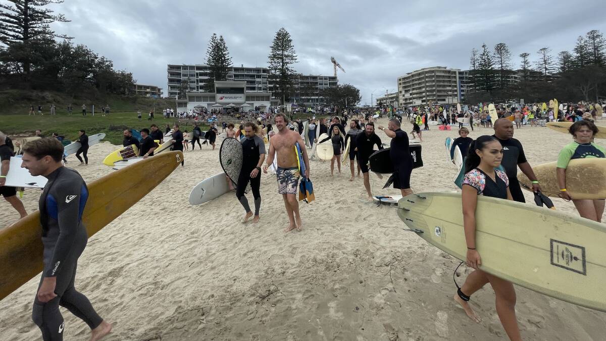 Surfers making their way out to the water at Town Beach for the world record attempt paddle out. Picture by Scott Calvin.
