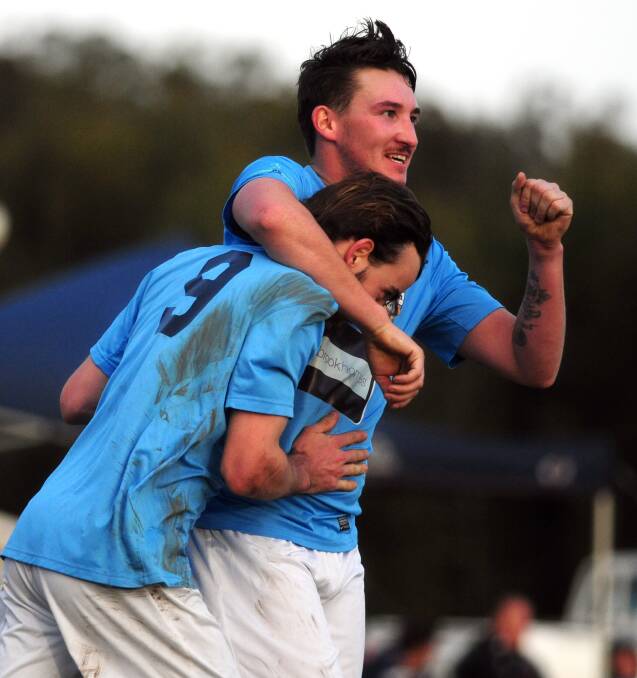 Goal brothers: Sam Wilson and Aaron Grose embrace after Wilson scored the fourth goal of Port FC's win over Wildcats on Saturday.