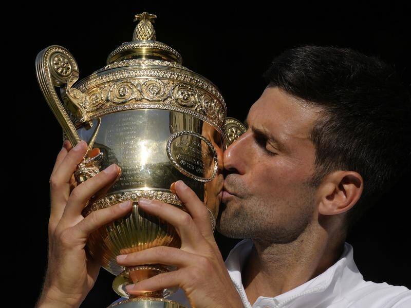 Novak Djokovic kisses the Challenge Cup after taking the Wimbledon men's title for the seventh time.