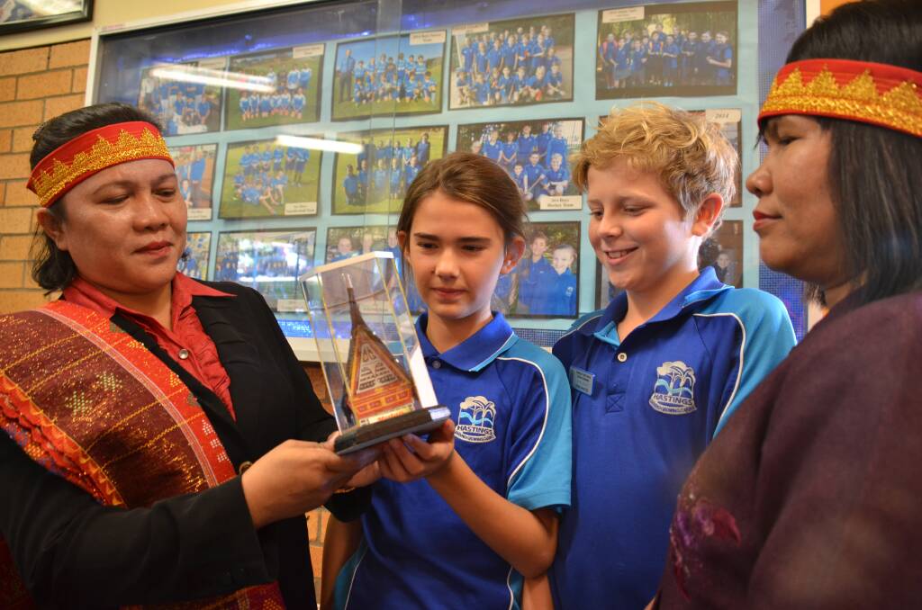 Special guests: Theresia Sianapur (left) and Lince Nainagolam (right) present school prime ministers Tait McIntye and Jesse Beard with gifts to the school.