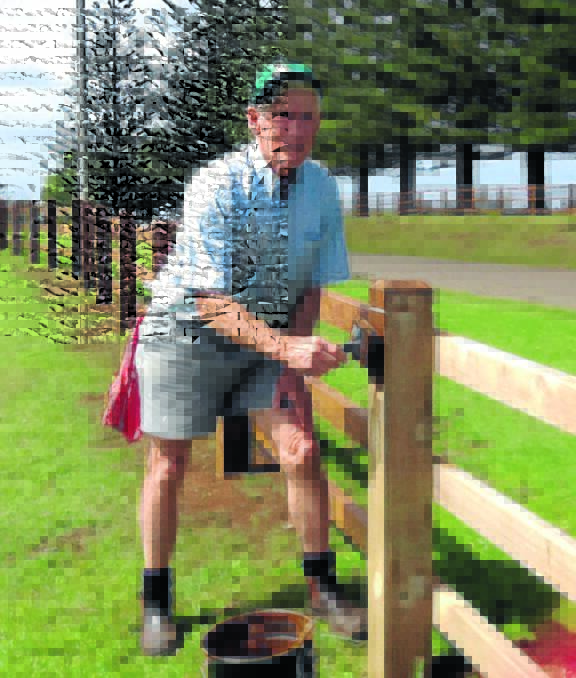 Top volunteer: Geoff Bond fixes a fence as part of his work with Outback Links which has seen him awarded as Mid North Coast Volunteer of the Year.