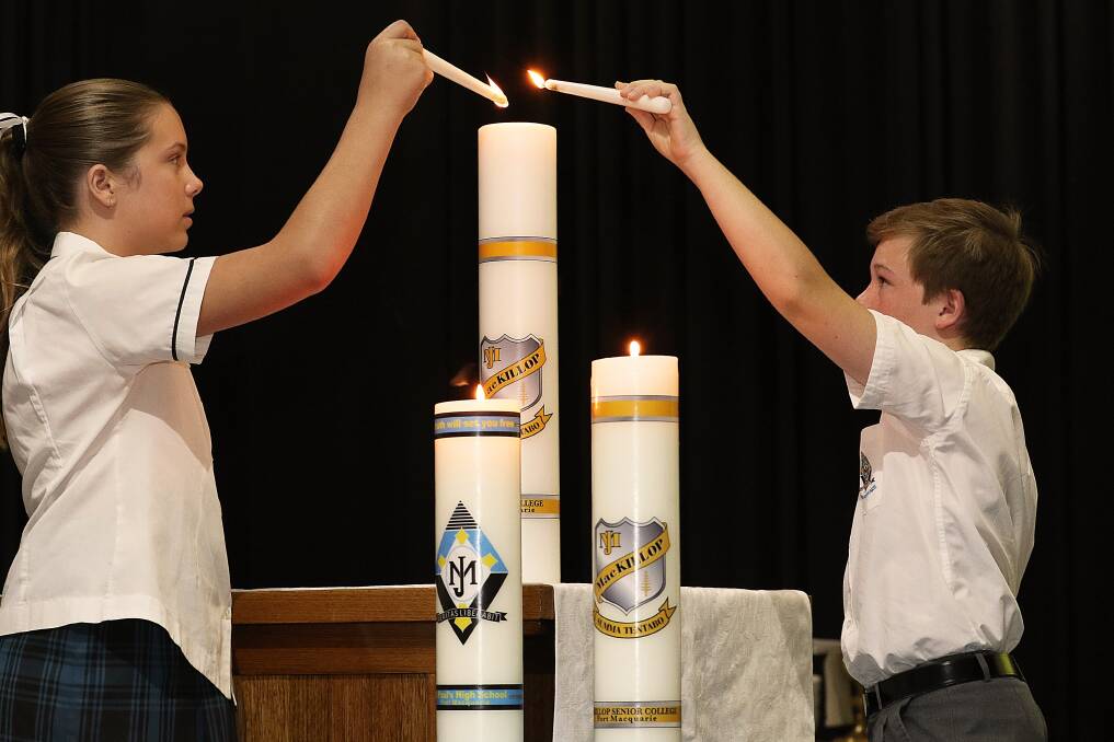 Burn brightly: Sarah Grave and Tobias Marsham light the college candle to signify the start of the school year.