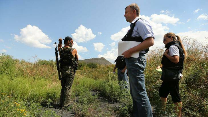 Deputy head of the OSCE mission, Alexander Hug, with pro-Russian rebel Yuri at the crash site. Photo: Kate Geraghty