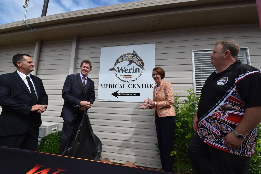 Important day: Cowper MP Luke Hartsuyker and Port Macquarie MP and Minister for Aboriginal Affairs Leslie Williams unveil a sign to mark Werin Aboriginal Medical Corporation's independence as Werin board chair Guy Jones and board secretary Warren Mason look on.