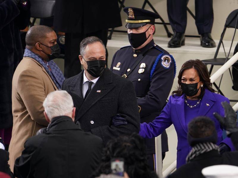 Capitol police officer Eugene Goodman (left) accompanied Kamala Harris at the inauguration.