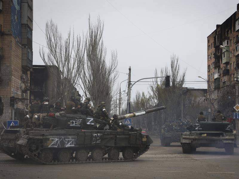 Russian military vehicles move in an area controlled by separatist forces in Mariupol.