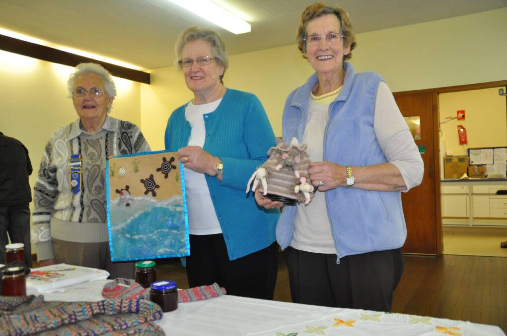 Handiwork: Wauchope CWA branch president Barbara Murphy, left, with a wall hanging she contributed to, along with branch handicraft officers Gwen Taylor and Hilda Saunders