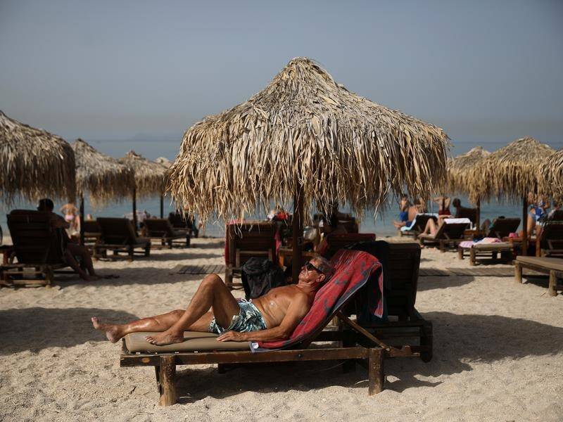 Greek sun-seekers were required to respect distancing rules when beaches reopened on Saturday.