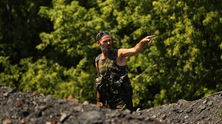 Pro-Russian rebel Yuri near where searchers look for remains and possessions near the MH17 crash site. Photo: Kate Geraghty