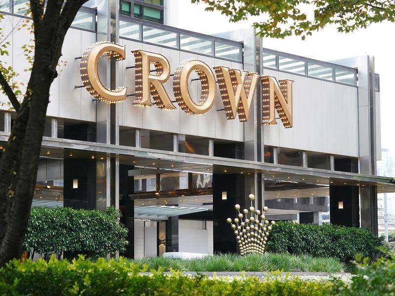 A gambling addict who lived at Melbourne's Crown Casino scammed $790,000 out of two men.