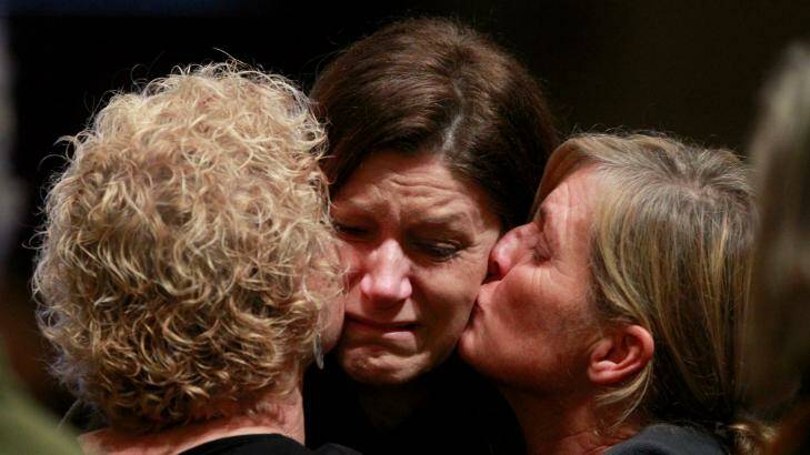 United in loss: Three of the mourners at Melbourne's St Patrick's Cathedral on Thursday.  Photo: Eddie Jim