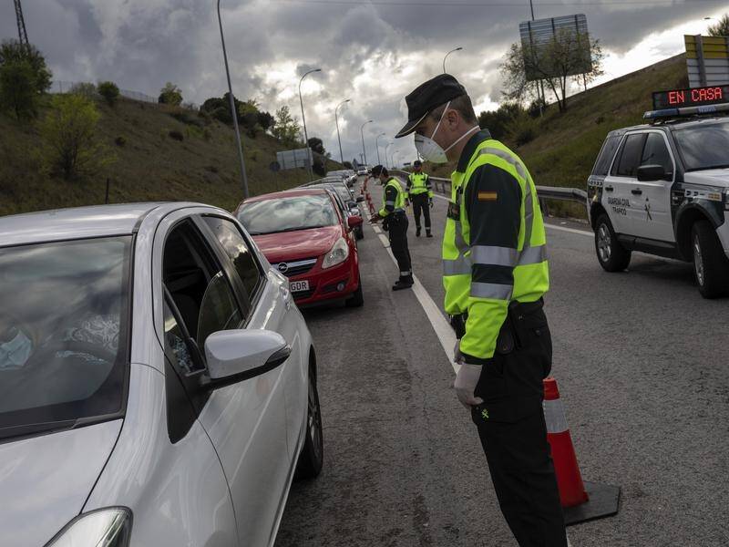Spanish Civil Guard officers near Madrid have stopped cars at checkpoints as the lockdown continues.
