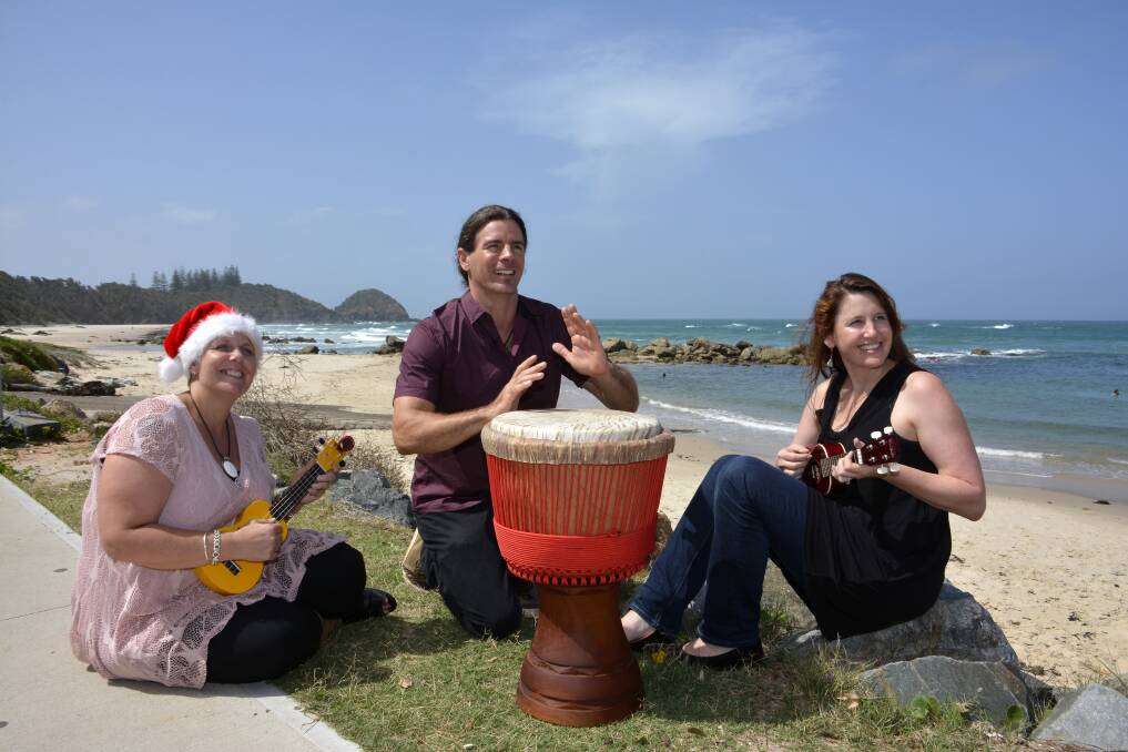 Summer celebration: Lucilla Marshall, drummer Ben Carey and Skye Frost preparing for Sunday's summer solstice at Shelly Beach on Sunday.