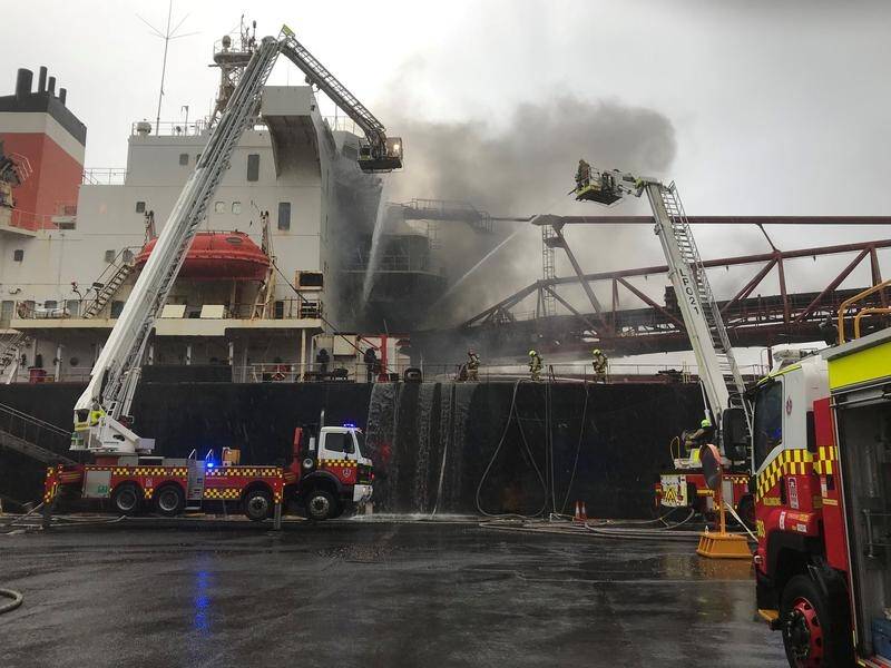 A fire aboard a ship on the NSW south coast appears to have been contained, firefighters say.