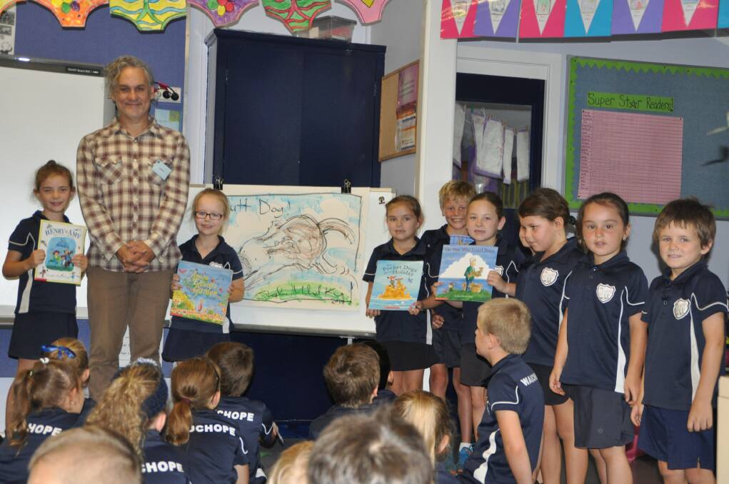 Keen readers: Posing with some of their favourite books by visiting author Stephen Michael King are Wauchope Public School year 1 students, from left, Tiana Daly, Shayla Campbell, Mikayla Hill, Will Newell, Talia Moran, Jayleigh Harris, Jasmin Ratko and Jesse Maiuri