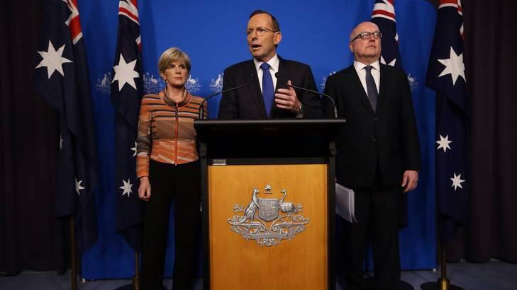 Confusion: Prime Minister Tony Abbott with Foreign minister Julie Bishop and Attorney-General Senator George Brandis. Photo: Andrew Meares