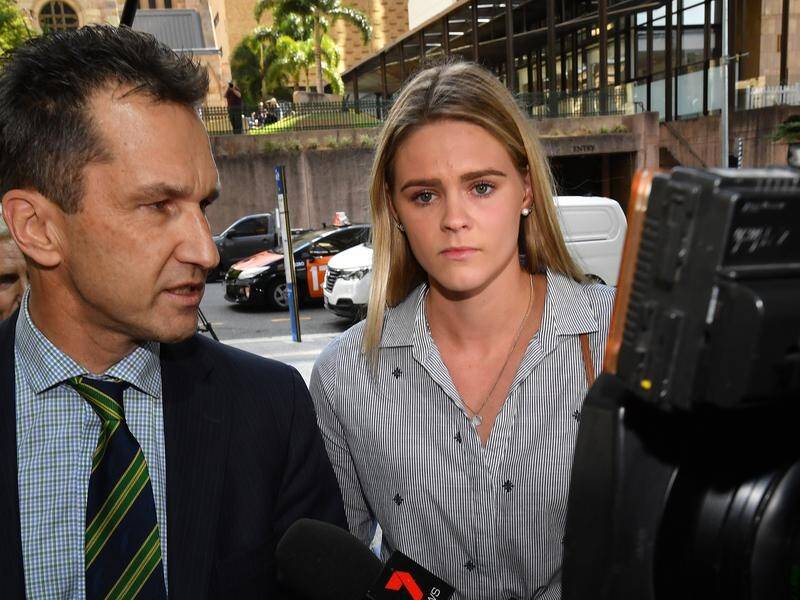 Australian swimmer Shayna Jack (C) arrives for a briefing with ASADA officials in Brisbane.
