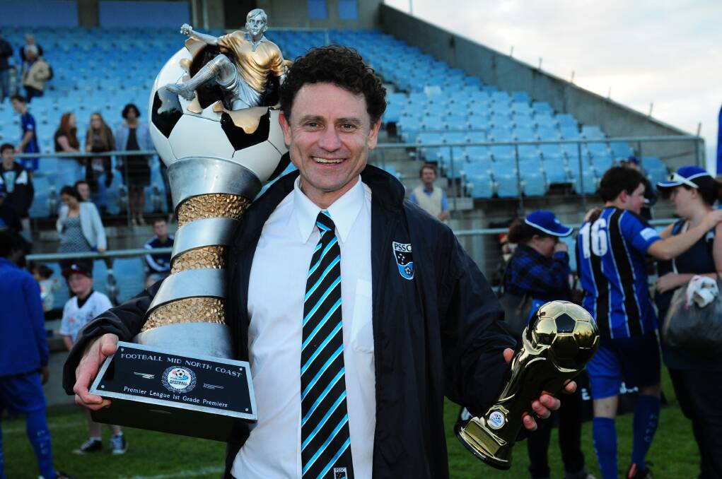 Victirious at last: Former Port Saints coach Peter Boskovski was thrilled to get his hands on the trophies after the Football Mid North Coast Premier League win over Camden Haven Redbacks on Saturday. Pic: MATT McLENNAN