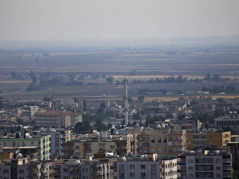 Kurdish fighters are leaving the Syrian town of Ras al Ain as part of a Turkish-US deal.