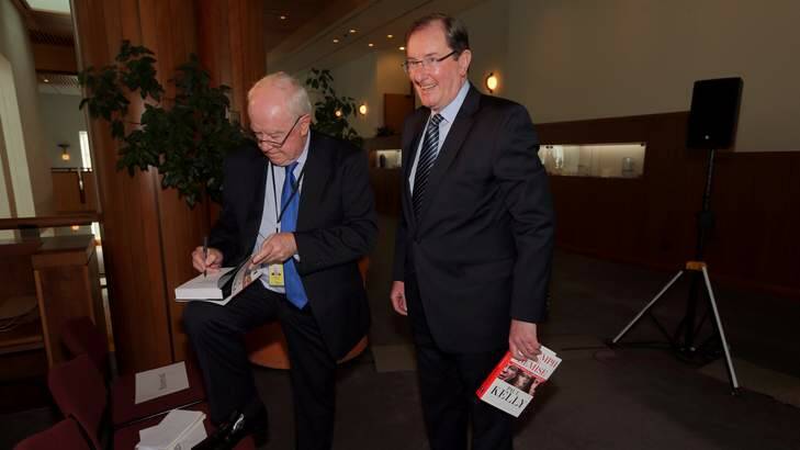 Author Paul Kelly signs his book for Brian Loughnane Federal Director of the Liberal Party on Tuesday. Photo: Andrew Meares