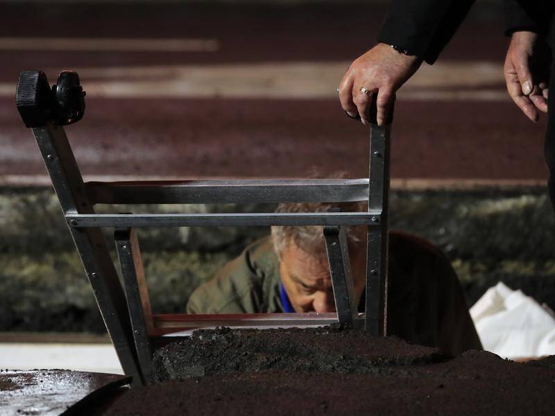 Artist Mike Parr has been dug out from underneath a Hobart street as part of the Dark Mofo festival.