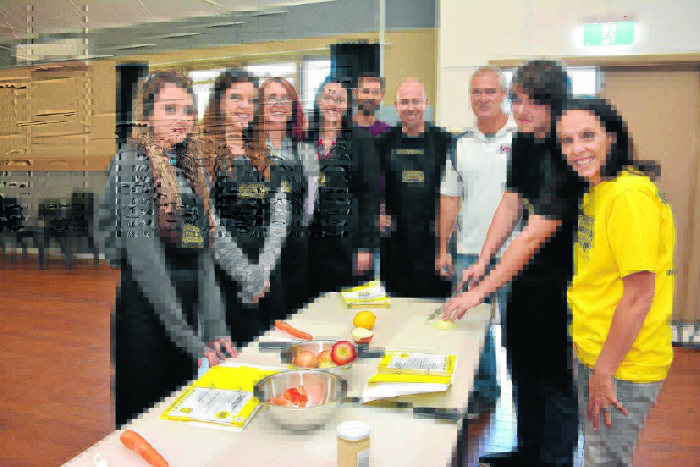 Healthy eating choices: NEST program students Zara Warren, Indy Miller and Christine Griffin, with manager of Woolworths Settlement City Kylie Hooper, Andrew Lord (teacher Port Macquarie Learning), Nick Johnson (Manager of NEST Oz Harvest), Mick Gilmour (Youth Hub manager), Connor Rees and Katrina Humble.
