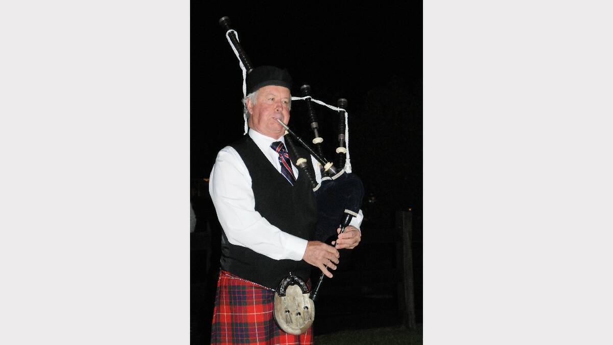 David Walker from the Plains Pipes and Drums plays the bagpipes.