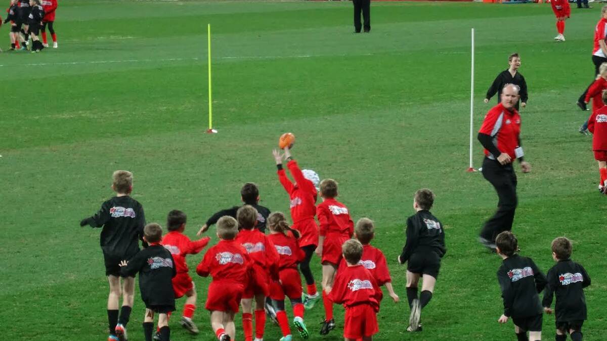 Opportunity of a lifetime: Port Macquarie kids run out onto the SCG on the weekend.