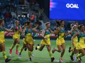 Australian Hockeyroos players celebrate winning the gold medal after the Women's Gold Medal Match against England at Glasgow National Hockey Centre. Photo: Getty Images