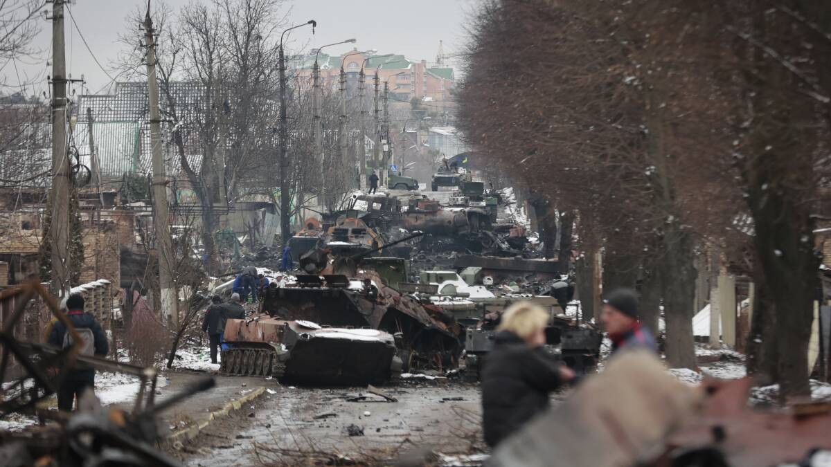 The gutted remains of Russian military vehicles line a road in Bucha, near Kyiv, on Tuesday. Picture: AP Photo