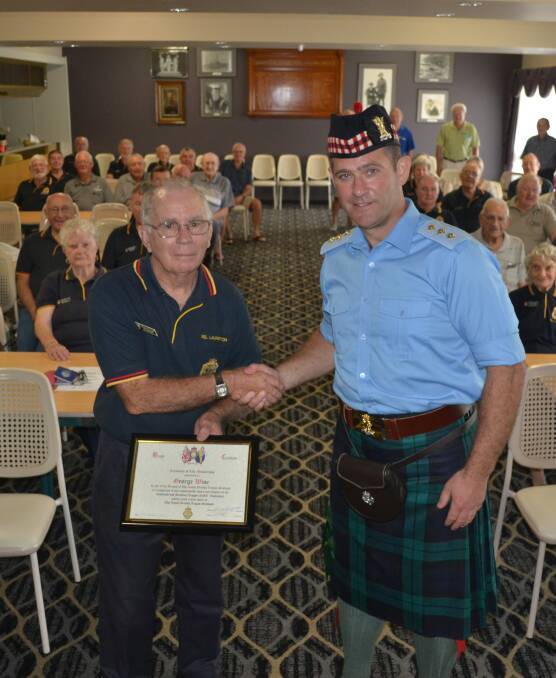 OFFICIALLY A SPECIAL MOMENT: Captain Richard Otley, right, presents Laurieton RSL Sub Branch secretary George Wise with honorary life membership.