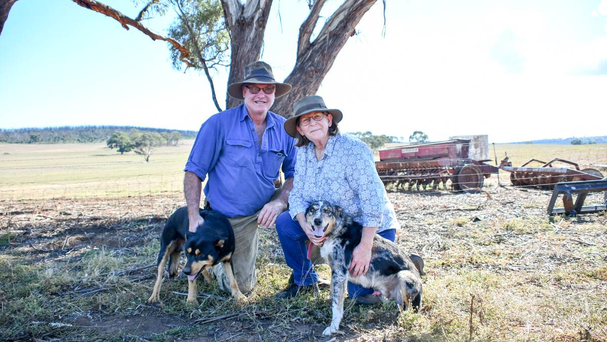 Graham and Jill Goodman with their two dogs who managed to shelter in their kennels and survive the Sir Ivan bushfire. 