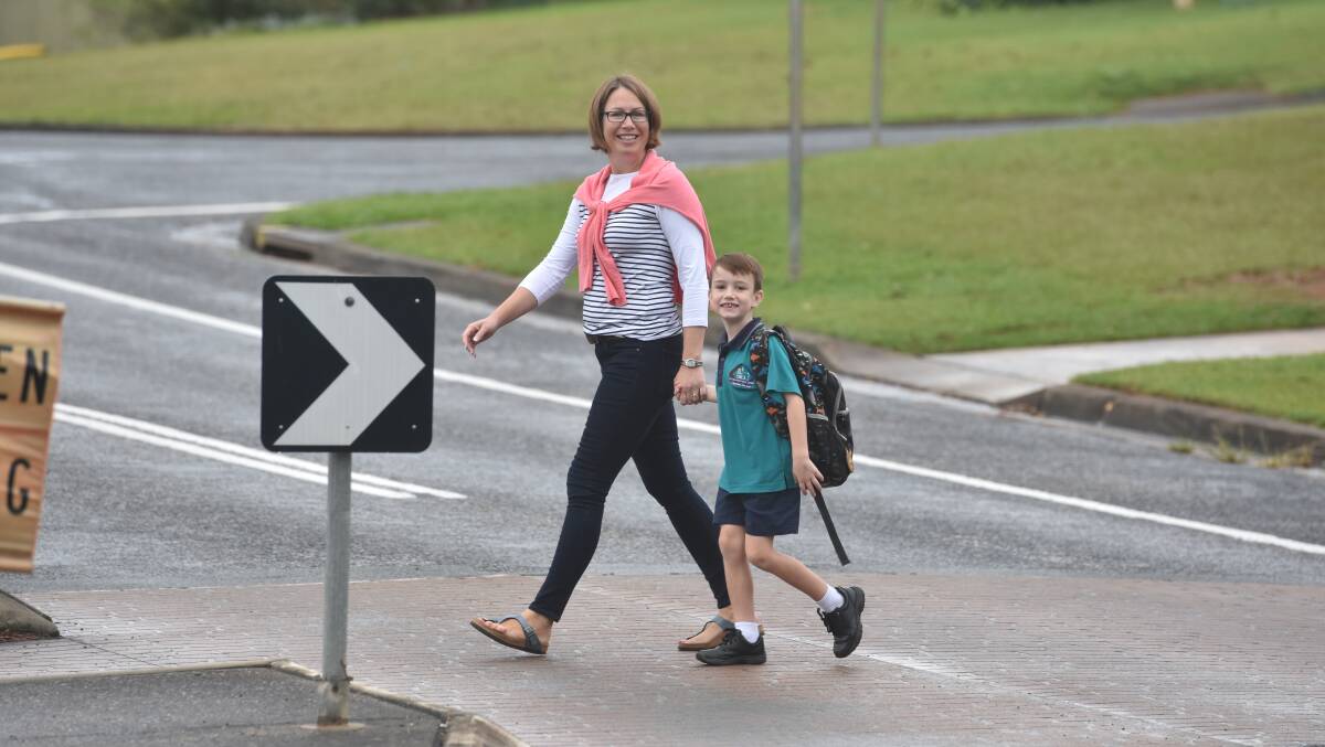 Kate Smead and her year one son Tom Smead use a pedestrian crossing to get to school. Photo: Matt Attard