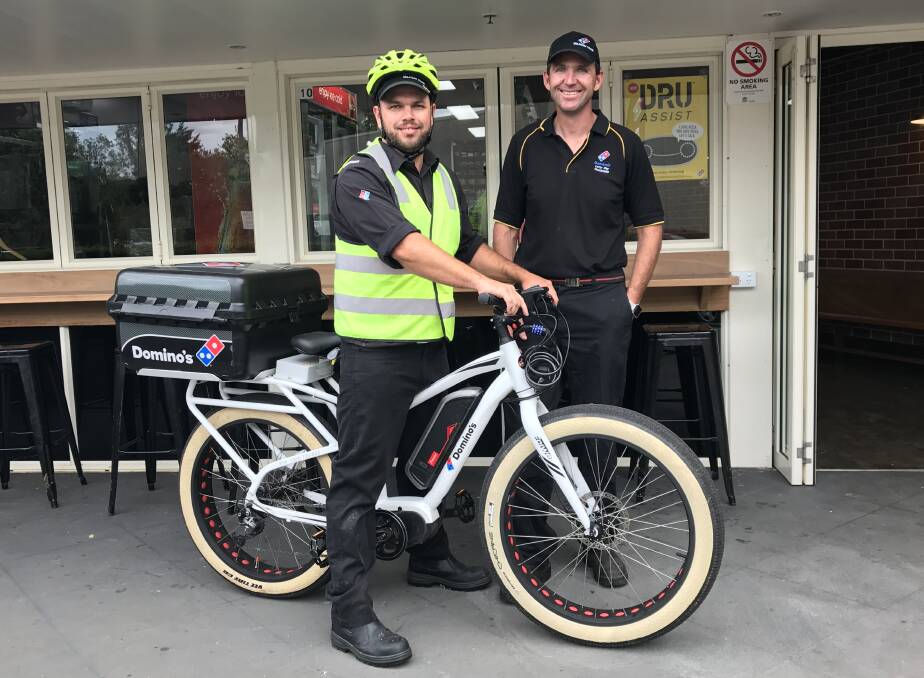 Lighthouse Beach store manager Brenton Moore with franchisee Leroy Day and their new e-bike. Photo: Matt Attard