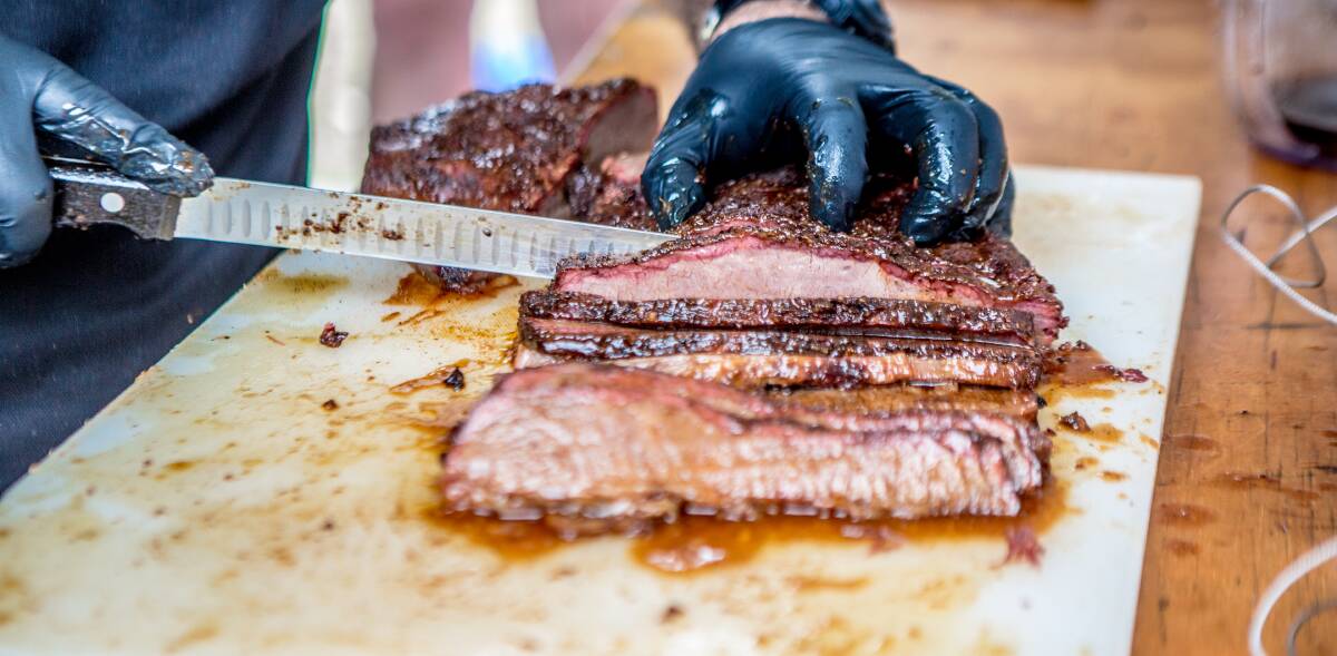 The holy grail: Beef brisket, slow smoked, being sliced at last year's barbecue competition in Port Macquarie. Photo: supplied.