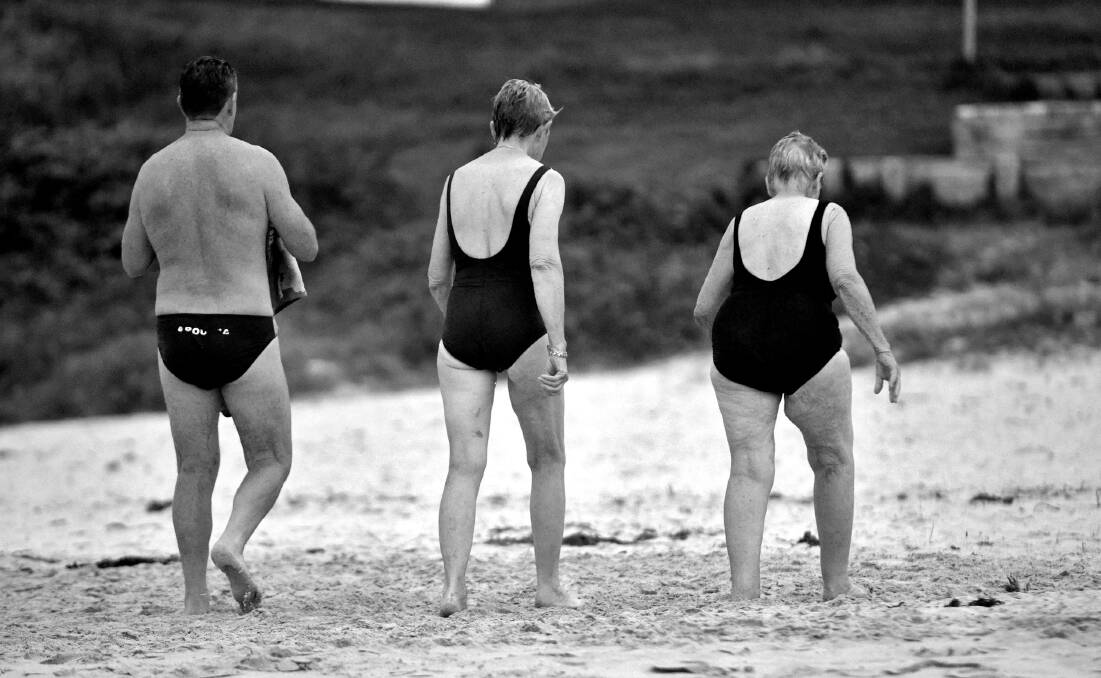 The simple things: Three members of the group head to the change rooms after their early morning swim. Photo: Matt Attard