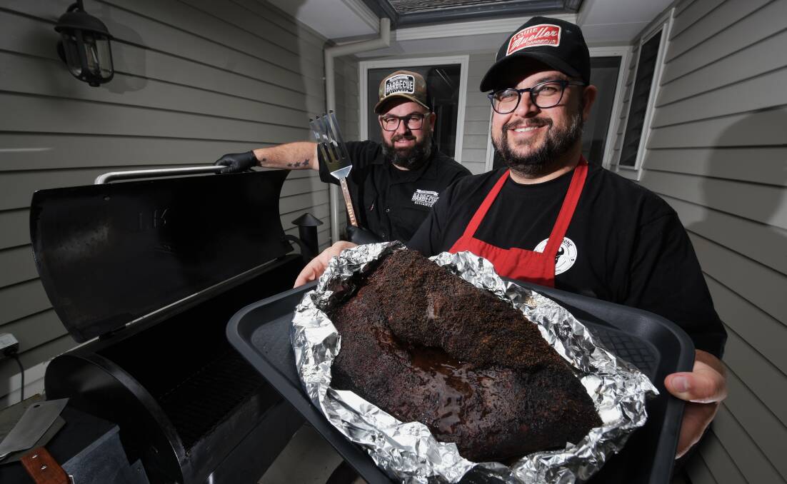 It's on: Beef in the Vines competitors Adam Roberts and Jay Beaumont, holding a smoked beef brisket, get some practice in before the main event. Photo: Matt Attard