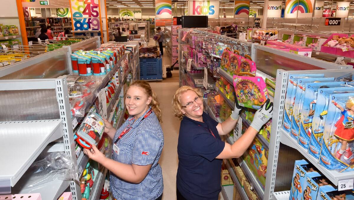 Toys aplenty: Ashleigh King and Fiona Cannon load up toys onto the shelves at the Port store.