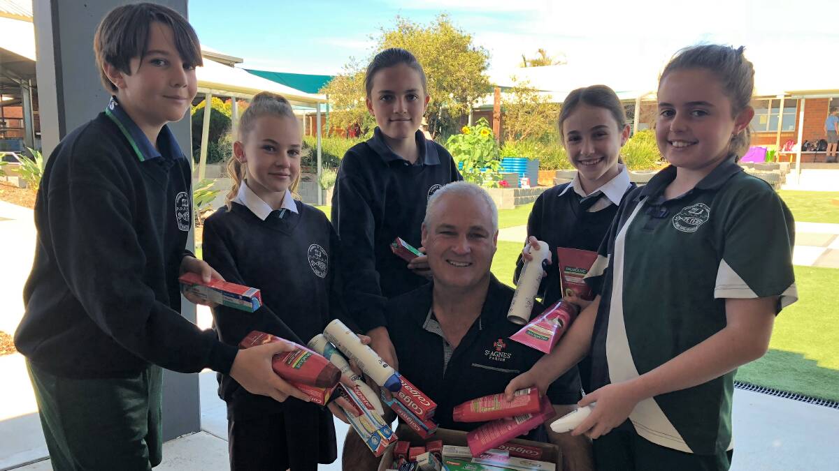 Helping hand: Students Patrik Markovic, Jaz Bruce, Josh Bell, Melesse Mallyan and Emily Woolfe with Youth Hub manager Mick Gilmore.